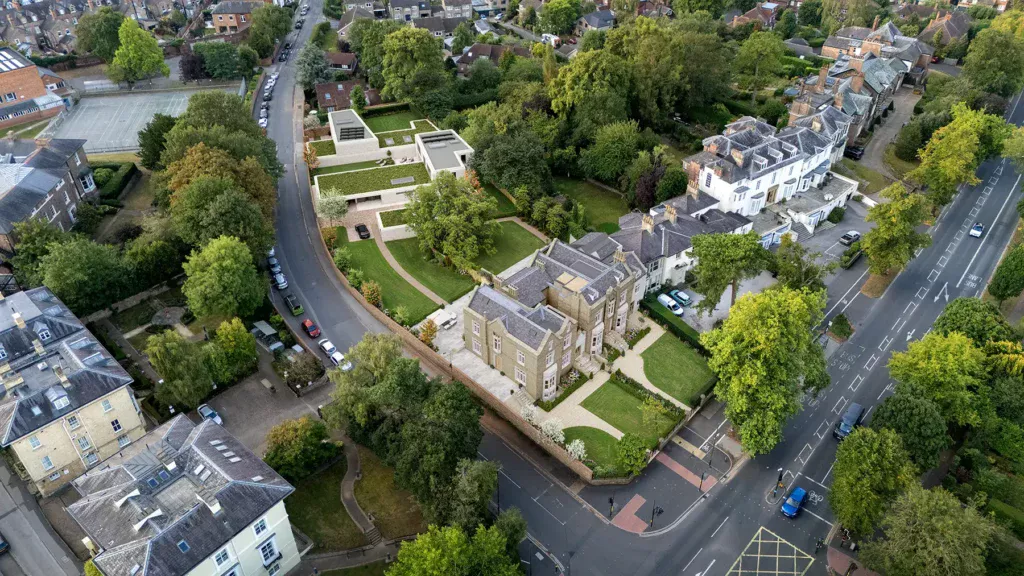 Architectural CGI aerial view of a large period property and contemporary annex set within landscaped grounds in York, surrounded by mature trees, nearby homes, and main road access.